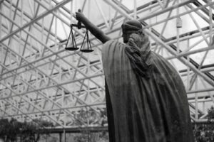 Statue of lady justice holding scales indoors