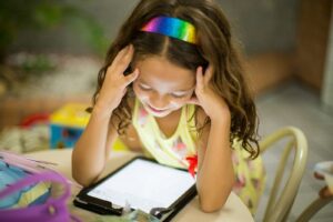 girl sitting on chair with tablet