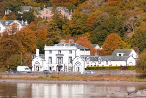 white and brown house near body of water during daytime